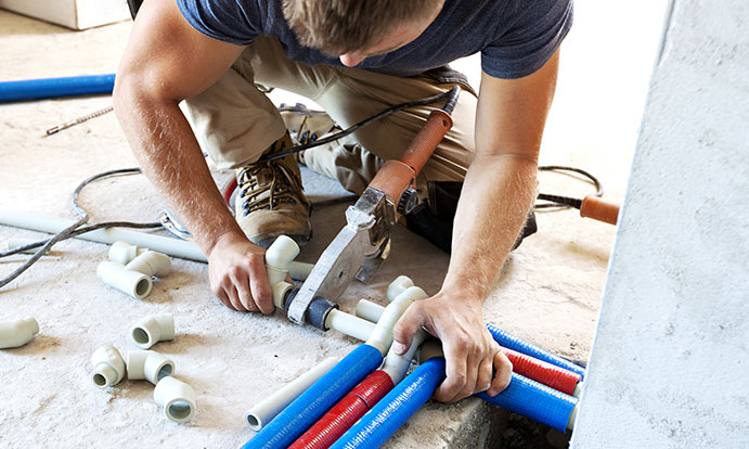 Plumber Repairing Pipe