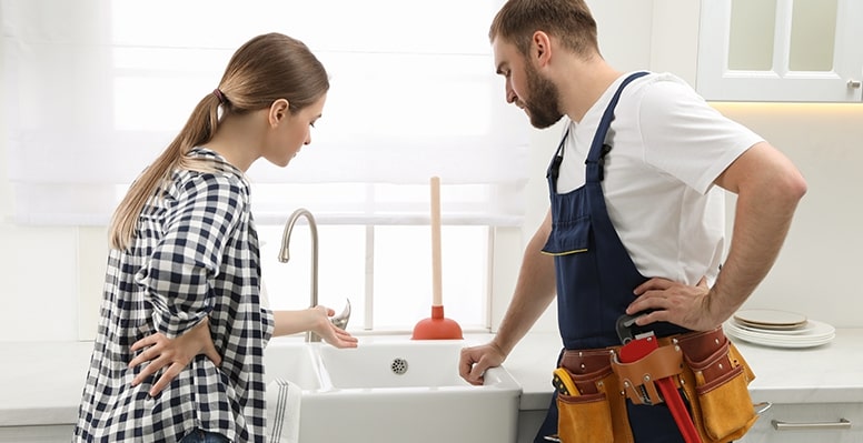 Plumber and Homewner Discussing Kitchen Sink